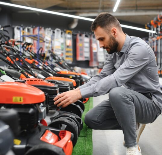 Robotniiduk ja murutraktor kõrvuti koduaias.